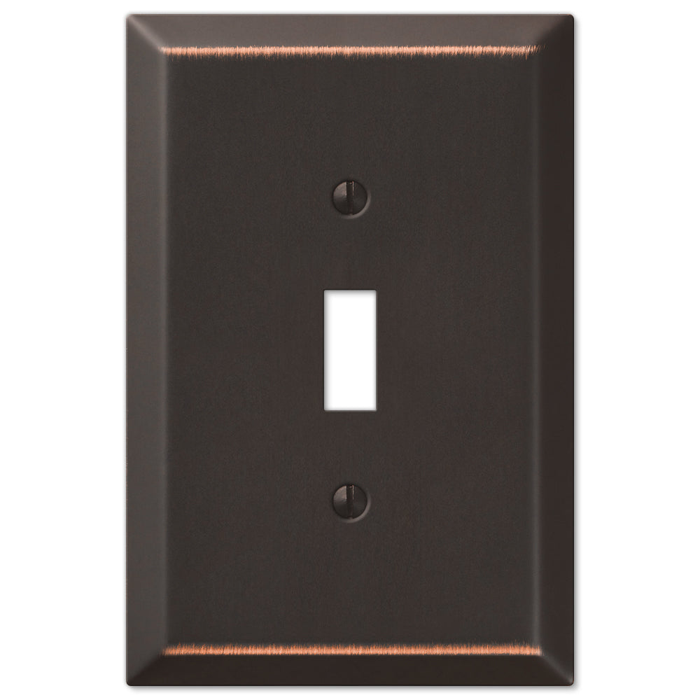 An oversized light switch cover made of aged bronze, featuring a textured, weathered surface with a rich, vintage patina, adding a timeless, antique feel to the switch.