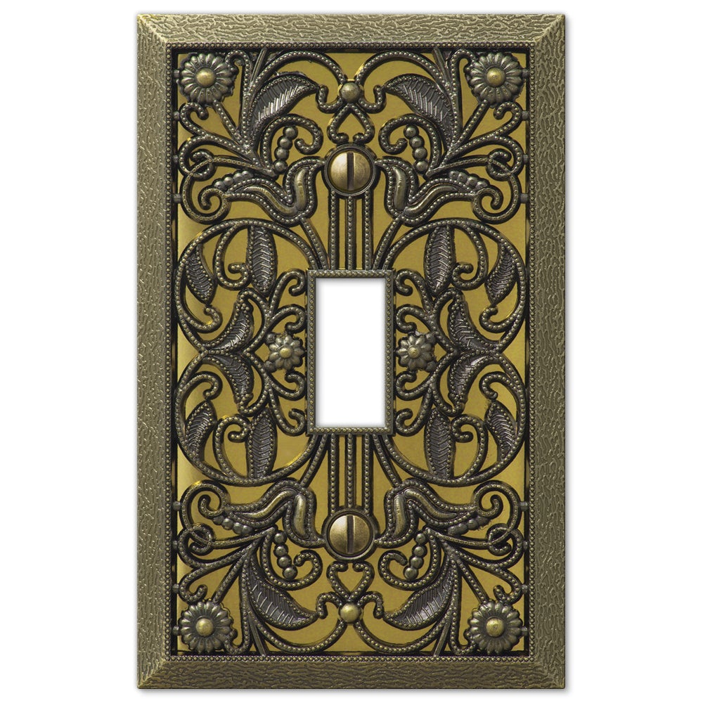 Filigree aged brass light switch cover featuring a detailed, ornate design with a warm brass finish, adding a classic and sophisticated touch to any room.