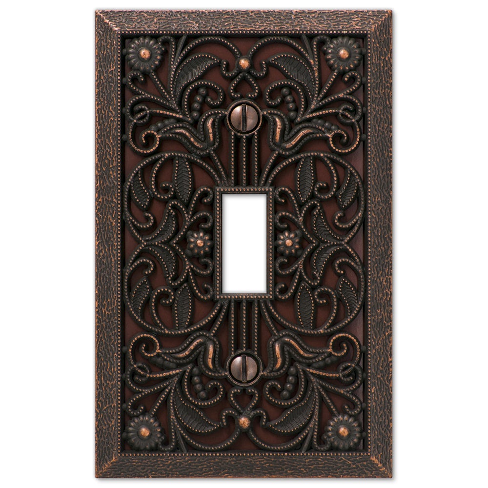 Filigree aged bronze light switch cover with an intricate, decorative design and a rich bronze finish, evoking a vintage charm and adding a touch of timeless elegance to any space.