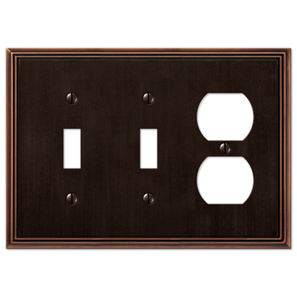 Metro Line double light switch and outlet wallplate in aged bronze, featuring a textured, antique finish with a refined, industrial design, adding a vintage touch to modern or rustic decor.