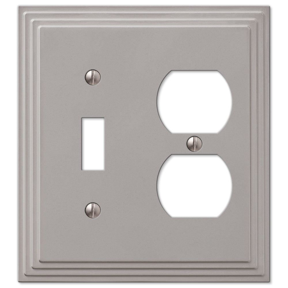 Steps light switch and outlet wallplate in satin nickel finish, designed with a tiered, geometric edge for a bold, architectural accent in any room.