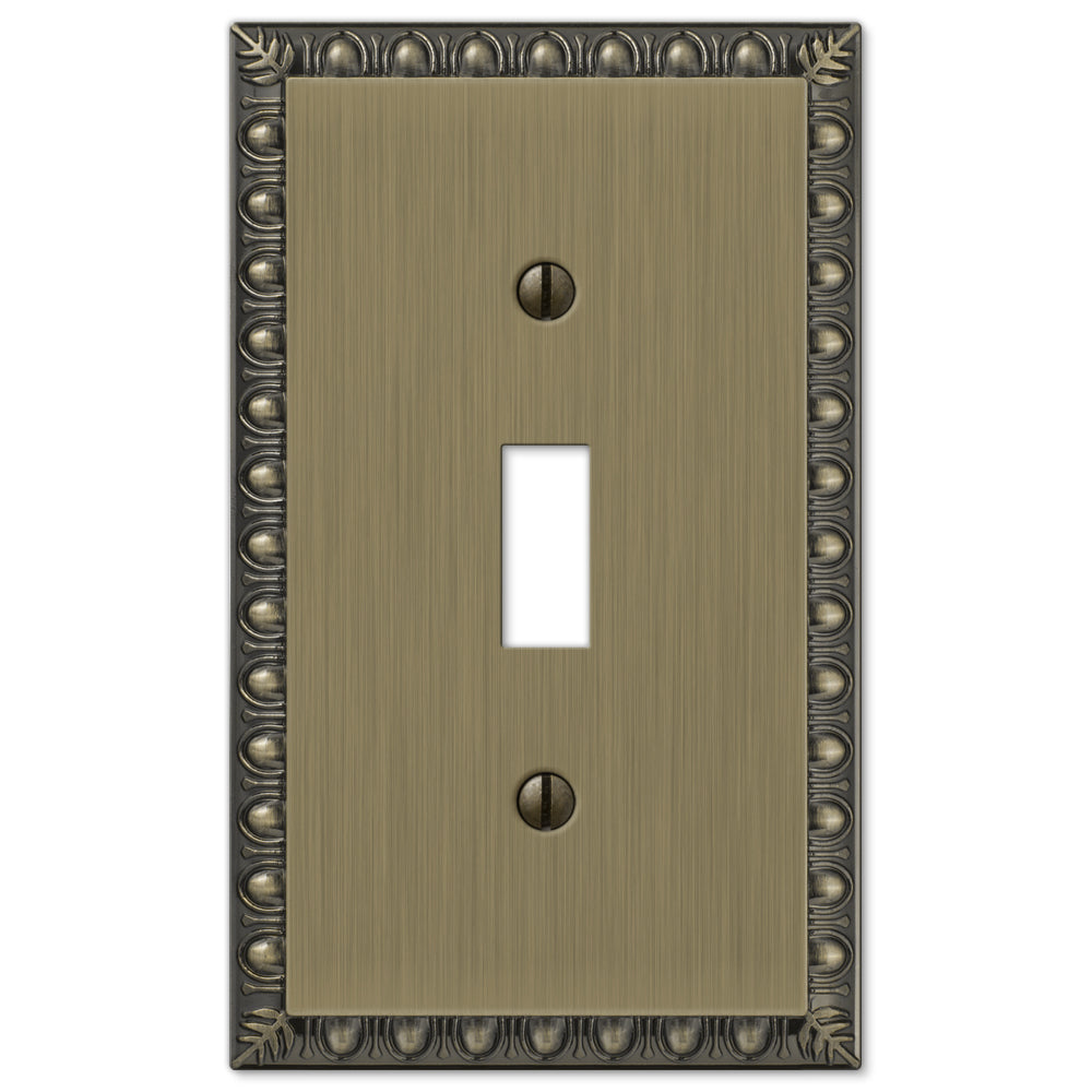 A brushed brass light switch cover with a gently weathered finish. The cover showcases a warm, muted surface with subtle patina, exuding a vintage yet sophisticated charm.