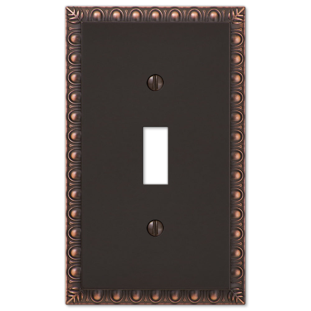 Close-up view of an aged bronze light switch cover with a rich, antique finish. The cover features a textured surface with a weathered patina, adding a vintage, timeless charm.