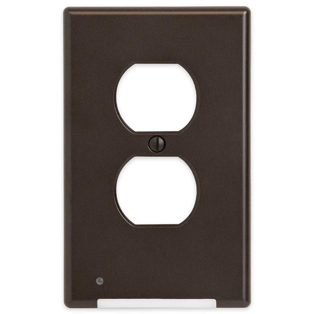 Aged Bronze LumiCover outlet wallplate with automatic low-light activation and a front-facing floodlight for power outages, featuring a self-charging rechargeable battery for reliable illumination.