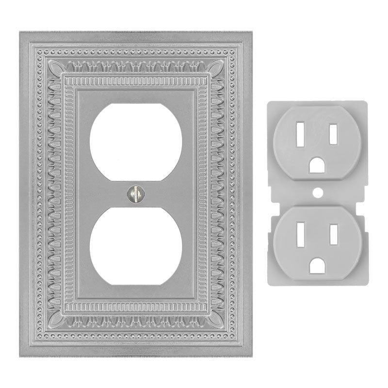 Filigree border satin nickel outlet wallplate featuring an intricate border design and a sleek satin nickel finish, offering a refined and modern touch of elegance to any space. The plug cover is set to the right of the wallplate.