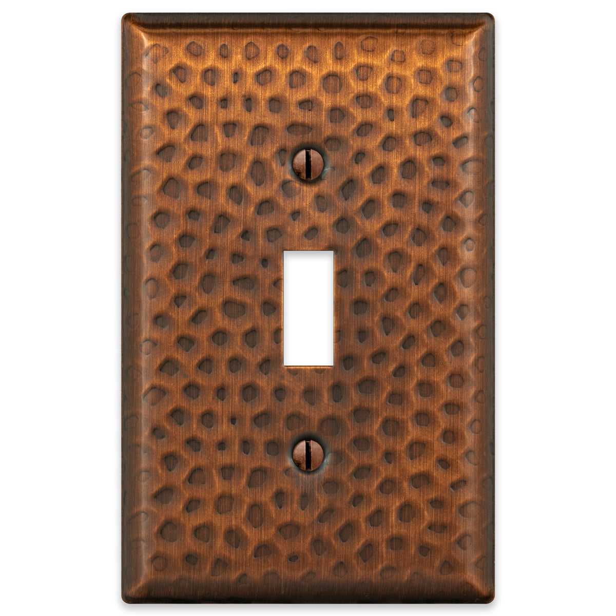 A hammered aged copper light switch cover featuring a textured surface with a warm, rustic copper finish, adding character and artisanal charm to traditional or farmhouse-style spaces.