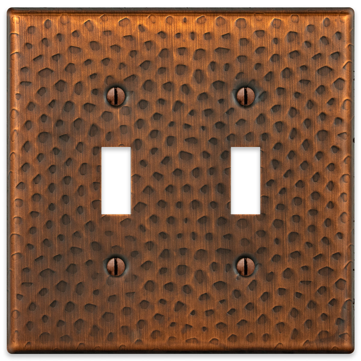 A hammered aged copper double light switch cover featuring a textured surface with a warm, rustic copper finish, adding character and artisanal charm to traditional or farmhouse-style spaces.